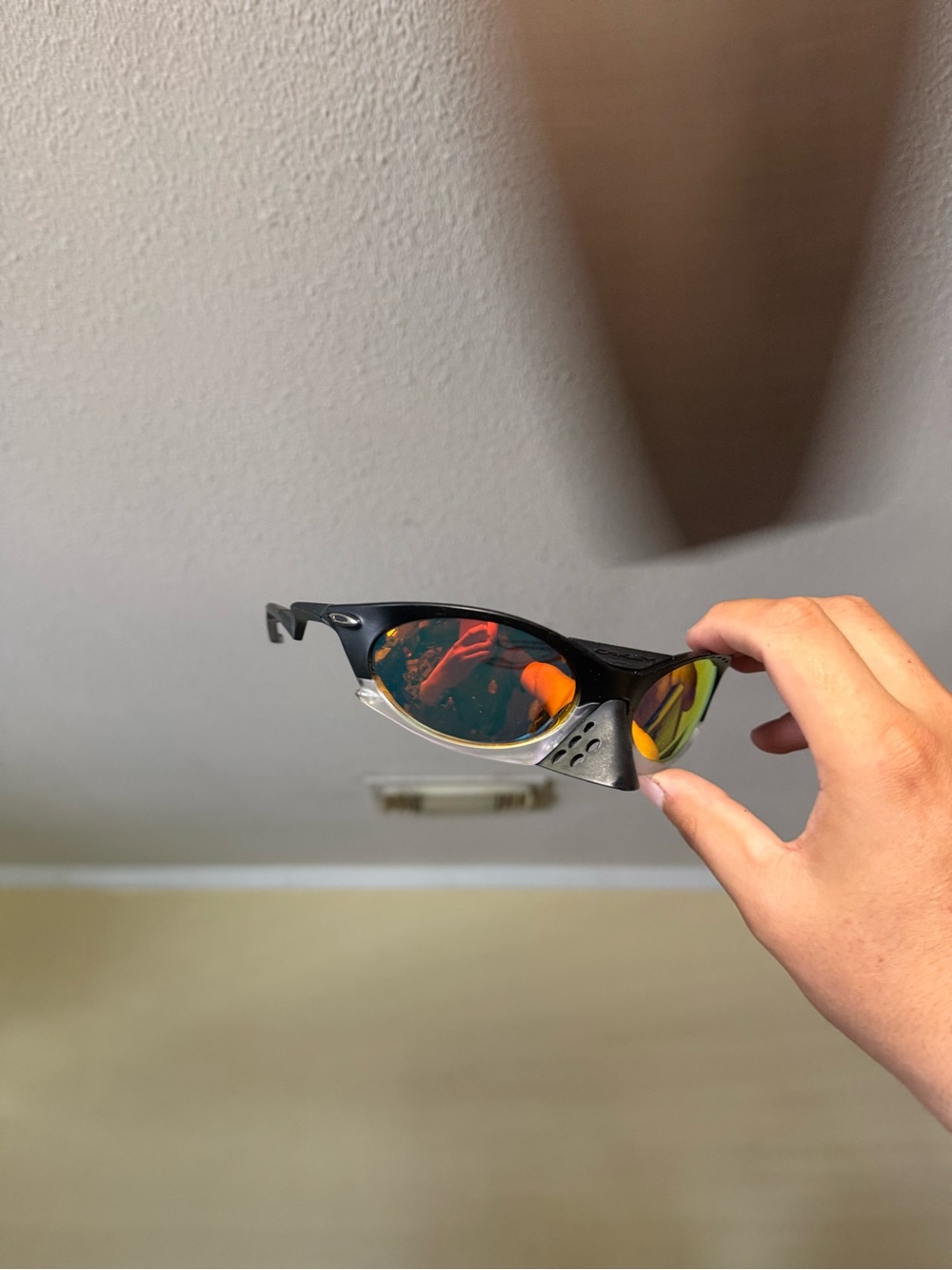 Oakley Black Frame Sunglasses with Orange-Red Mirrored Lensesoakley